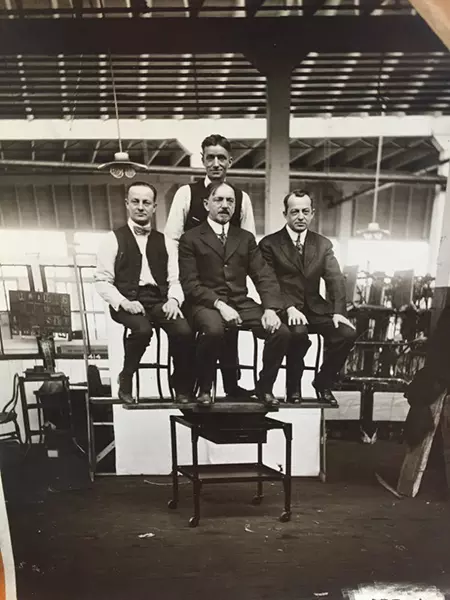 Tom, Otto, Phil and Henry Uhl demonstrating the strength of their furniture