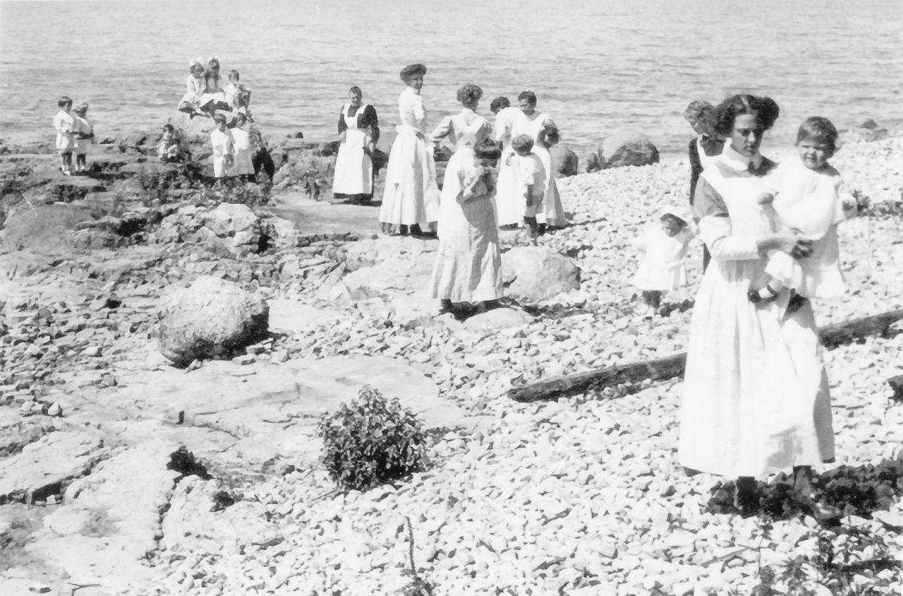 Middle Bass Club:  Nurse Maids with children playing on the shore of Lake Erie.