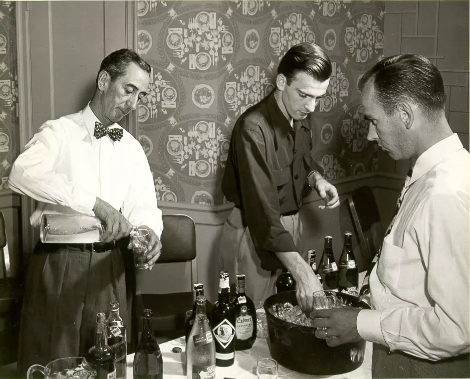 C.F. Greenhill pouring a drink. 1949 Salesmans Conference