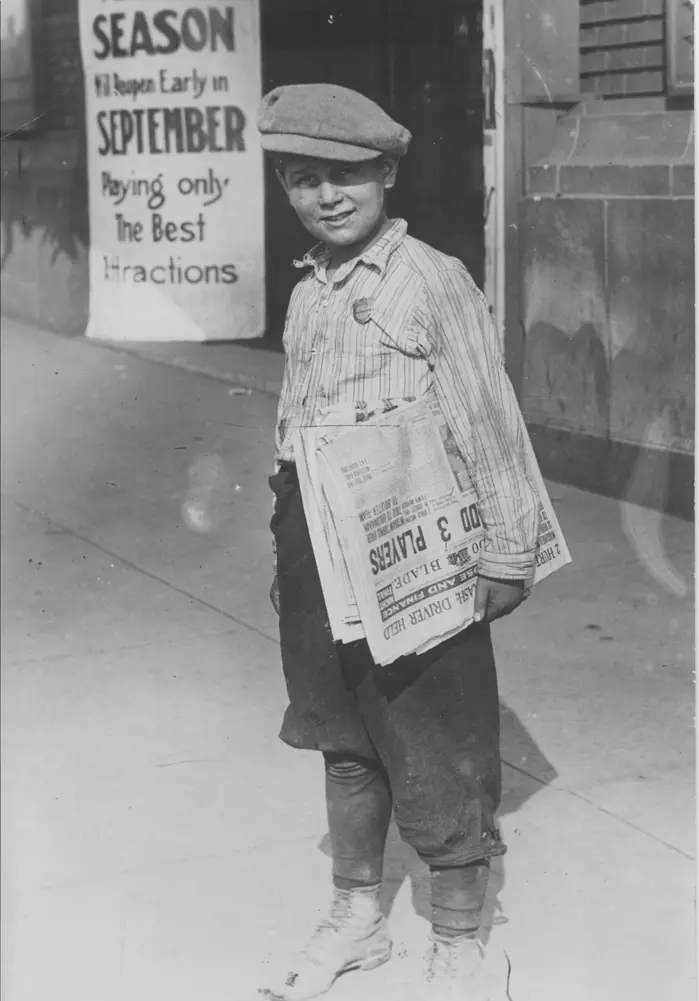 A newsboy selling the Toledo Blade