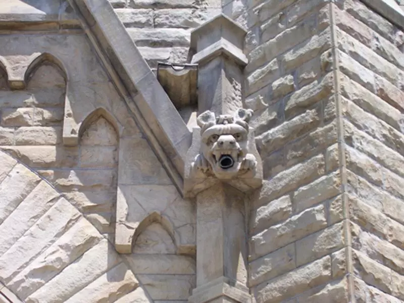 One of two gargoyles high above on the front facade of the church